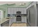 Well-equipped kitchen featuring stainless steel appliances and ample cabinet space, perfect for culinary enthusiasts at 1453 Maple Leaf Ln, Deland, FL 32724