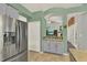 Bright eat-in kitchen with stainless steel refrigerator and pass-through to the living area at 1453 Maple Leaf Ln, Deland, FL 32724
