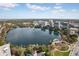 Expansive aerial view of a lake, showcasing the skyline and surrounding green landscape at 151 E Washington St # 424, Orlando, FL 32801