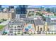 Aerial view of a building complex highlighting its rooftop pool, cabana, architectural details, and urban surroundings at 151 E Washington St # 424, Orlando, FL 32801