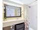 Bright bathroom featuring a large mirror, fresh vanity, and shower/tub combo with decorative curtain at 151 E Washington St # 424, Orlando, FL 32801