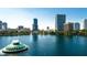 Vibrant cityscape view featuring a scenic lake with a fountain and a skyline of modern buildings at 151 E Washington St # 424, Orlando, FL 32801