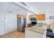Efficient kitchen area with granite countertop, stainless steel refrigerator, and warm wood cabinetry at 151 E Washington St # 424, Orlando, FL 32801