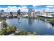 Scenic view of Lake Eola surrounded by downtown Orlando's skyline under a bright blue sky at 151 E Washington St # 424, Orlando, FL 32801