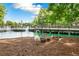Scenic lake view with fountain, pedestrian bridge, and group of geese enjoying the outdoors in a vibrant community at 151 E Washington St # 424, Orlando, FL 32801