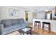 Inviting living room with stylish gray sofa, modern art, and an open layout to the kitchen and dining area at 151 E Washington St # 424, Orlando, FL 32801