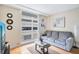 Comfortable living room featuring couch, hardwood floors, and natural light from the large window at 151 E Washington St # 424, Orlando, FL 32801