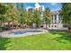 Beautiful park view featuring a blue fountain and a green lawn in front of a historical building at 151 E Washington St # 424, Orlando, FL 32801