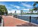Charming waterfront promenade with a brick walkway, black railings, and a scenic view of the lake and city skyline at 151 E Washington St # 424, Orlando, FL 32801