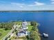 This aerial view highlights the expansive backyard, lake access, pool, and dock at 15787 Tangerine Dream Ct, Winter Garden, FL 34787