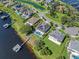 This is an aerial view of the home, pool, boat dock, and lakefront property, nestled in a waterfront community at 15787 Tangerine Dream Ct, Winter Garden, FL 34787