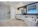 Bright bathroom with white cabinets, a walk-in shower, and a soaking tub at 15787 Tangerine Dream Ct, Winter Garden, FL 34787