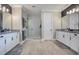 Bright bathroom with dual vanities, a walk-in shower, and wood-look tile floors at 15787 Tangerine Dream Ct, Winter Garden, FL 34787