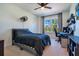 Well-lit bedroom featuring a queen-size bed and a ceiling fan at 15787 Tangerine Dream Ct, Winter Garden, FL 34787