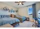 Comfortable bedroom with two twin beds and a ceiling fan at 15787 Tangerine Dream Ct, Winter Garden, FL 34787