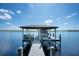 This boat dock features a covered boat lift and seating, offering easy access to the open water at 15787 Tangerine Dream Ct, Winter Garden, FL 34787