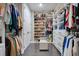 Walk-in closet with ample storage space, built-in shelving, and a seating area at 15787 Tangerine Dream Ct, Winter Garden, FL 34787