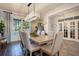 Formal dining room featuring a large window, decorative chandelier, and wood flooring at 15787 Tangerine Dream Ct, Winter Garden, FL 34787