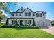 Charming two-story home with a well-manicured lawn, three-car garage, and beautiful curb appeal at 15787 Tangerine Dream Ct, Winter Garden, FL 34787