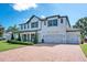 Beautiful two-story home with a three-car garage, lush landscaping, and brick-paved driveway at 15787 Tangerine Dream Ct, Winter Garden, FL 34787