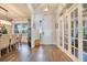 Bright foyer with wood floors, chandelier lighting, front door and access to the formal dining room at 15787 Tangerine Dream Ct, Winter Garden, FL 34787