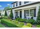 Inviting front porch with seating area, manicured landscaping and brick walkway to the front door at 15787 Tangerine Dream Ct, Winter Garden, FL 34787