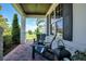 Charming covered front porch with stone accents and cozy seating area with a view at 15787 Tangerine Dream Ct, Winter Garden, FL 34787