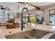 Bright kitchen features a modern faucet, stainless steel sink, and views of the backyard at 15787 Tangerine Dream Ct, Winter Garden, FL 34787
