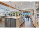 Open-concept kitchen with a large island, pendant lighting, and stainless steel appliances at 15787 Tangerine Dream Ct, Winter Garden, FL 34787