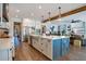 Modern kitchen with stainless appliances, large island, hardwood floors, and a view of the living room at 15787 Tangerine Dream Ct, Winter Garden, FL 34787