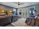 Cozy living room with a leather couch and doors to the screened porch at 15787 Tangerine Dream Ct, Winter Garden, FL 34787