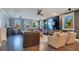 Spacious living room featuring a large screen TV and hardwood floors at 15787 Tangerine Dream Ct, Winter Garden, FL 34787