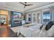 Main bedroom features a fireplace, balcony access, and stunning water views at 15787 Tangerine Dream Ct, Winter Garden, FL 34787