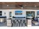 The outdoor bar area provides ample seating, a tv, and is perfect for watching sports and enjoying the fresh air at 15787 Tangerine Dream Ct, Winter Garden, FL 34787