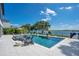 Relax by this luxury pool and hot tub with beautiful lake views, lush landscaping, and stylish seating at 15787 Tangerine Dream Ct, Winter Garden, FL 34787
