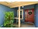 Inviting front porch with a red door, wreath, seating area, and the house number on display at 171 Cedarpark Ln, Davenport, FL 33837