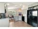 Modern kitchen with stainless steel appliances, gray cabinets, and a center island for meal preparation at 171 Cedarpark Ln, Davenport, FL 33837