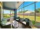 Screened-in lanai with comfortable seating, offering a relaxing outdoor space with a view of the yard at 171 Cedarpark Ln, Davenport, FL 33837