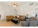 Bright and inviting living room with vaulted ceilings, hardwood floors, and comfortable seating at 171 Cedarpark Ln, Davenport, FL 33837