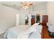 Bright main bedroom with ceiling fan, walk-in closet, and open view to other living spaces at 171 Cedarpark Ln, Davenport, FL 33837