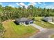 Aerial view of a gray single-story home with a blue garage door and a paved driveway at 17445 Sw 41St Cir, Ocala, FL 34473