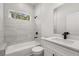 Bathroom featuring white tile, black fixtures, tub and shower at 17445 Sw 41St Cir, Ocala, FL 34473