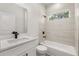 Modern bathroom with white tile, black fixtures, tub and shower at 17445 Sw 41St Cir, Ocala, FL 34473