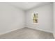 Neutral bedroom featuring wood-look floors and large window at 17445 Sw 41St Cir, Ocala, FL 34473