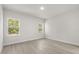 Bright bedroom features two windows, neutral paint, and wood-look floors at 17445 Sw 41St Cir, Ocala, FL 34473