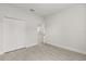Neutral bedroom with light wood-look floors, closet, and open doorway at 17445 Sw 41St Cir, Ocala, FL 34473