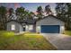 Charming single-story home featuring a blue garage door and well-maintained front yard at 17445 Sw 41St Cir, Ocala, FL 34473