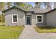 Inviting home facade with a paved walkway leading to a blue front door at 17445 Sw 41St Cir, Ocala, FL 34473