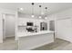 Bright kitchen boasts an island with breakfast bar, stainless steel appliances, and white cabinets at 17445 Sw 41St Cir, Ocala, FL 34473