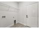 Functional laundry room with wire shelving, hookups, and a white exterior door at 17445 Sw 41St Cir, Ocala, FL 34473
